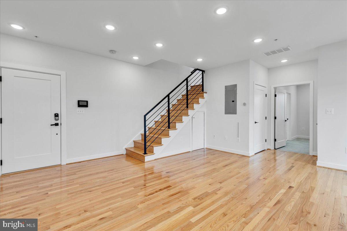 1416 22nd Street Southeast, Unit 9 Washington, DC 20020 - Photo 6 of 31 a view of an empty room with wooden floor and entryway