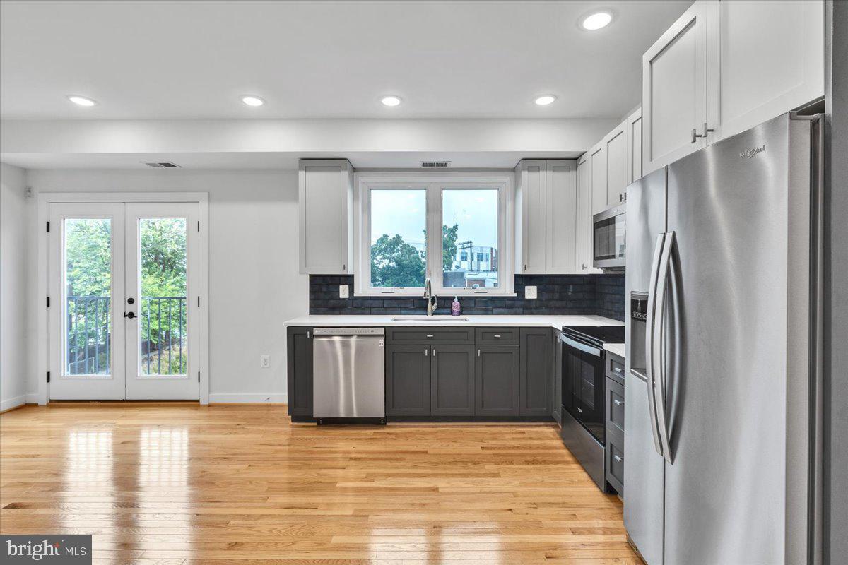 1416 22nd Street Southeast, Unit 9 Washington, DC 20020 - Photo 8 of 31 a kitchen with stainless steel appliances granite countertop a refrigerator sink and stove