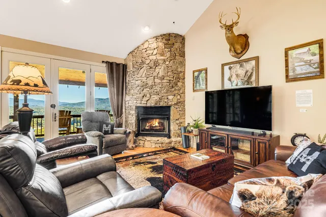 a living room with furniture a flat screen tv and a large window