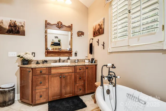 a spacious bathroom with a double vanity sink a mirror and a toilet