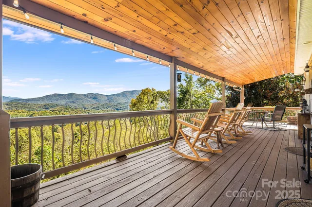 a view of balcony with wooden floor and outdoor seating