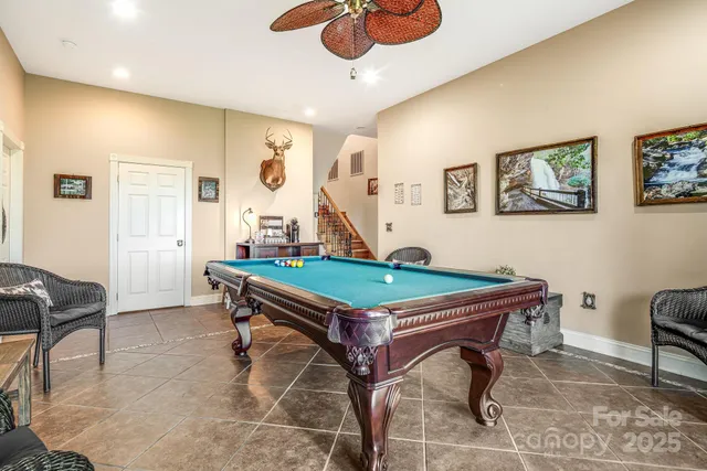 a room with furniture pool table and window