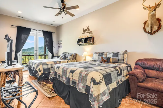 a bedroom with a bed a couch and a large window