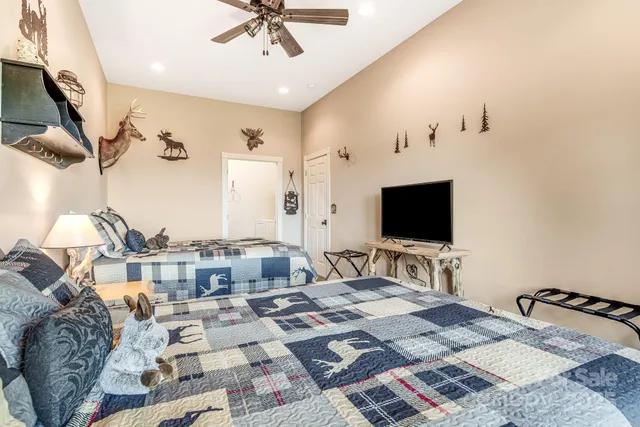 a bedroom with furniture and a flat screen tv