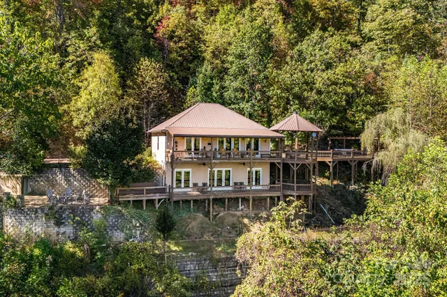 a roof deck with table and chairs under an umbrella