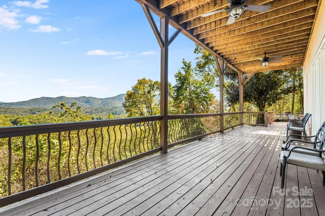a view of balcony with wooden floor and fence