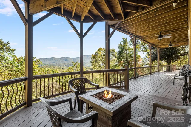 a view of a balcony with wooden floor and outdoor seating