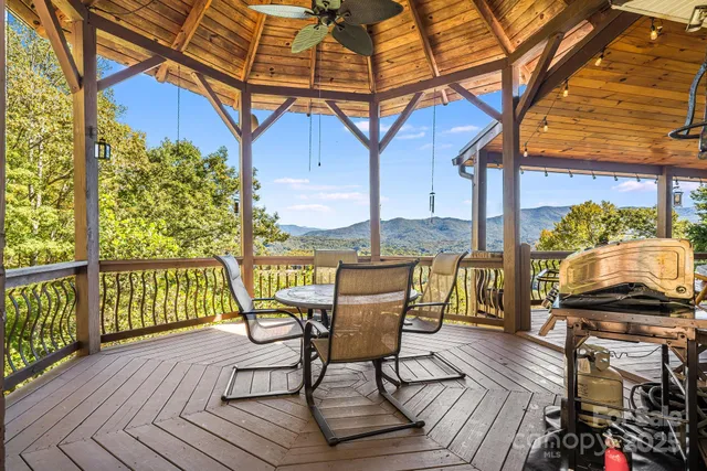 a view of a balcony with furniture and wooden floor