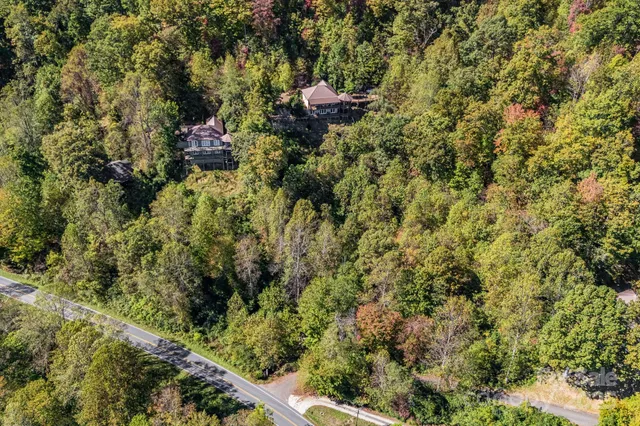 a backyard of a house with a yard and outdoor seating