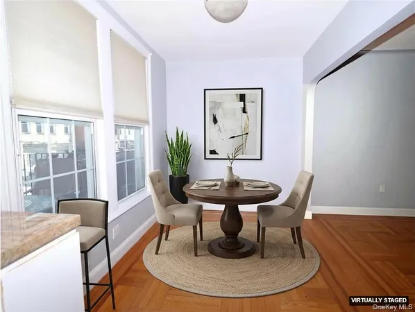 a view of a dining room with furniture and wooden floor