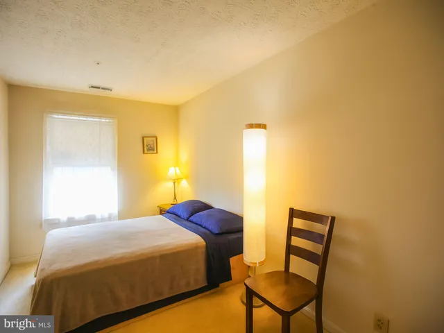 a bedroom with a bed and chair