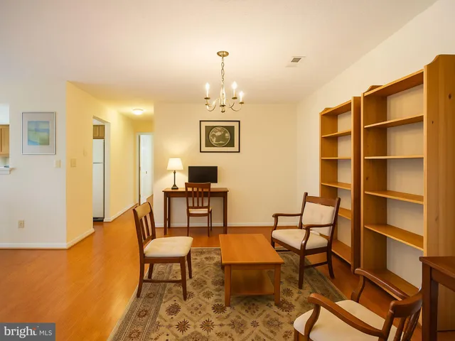 a living room with furniture a rug and a chandelier