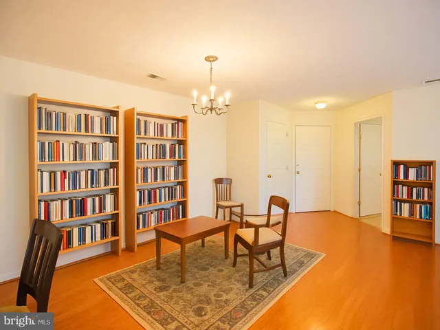 a living room with furniture and a book shelf