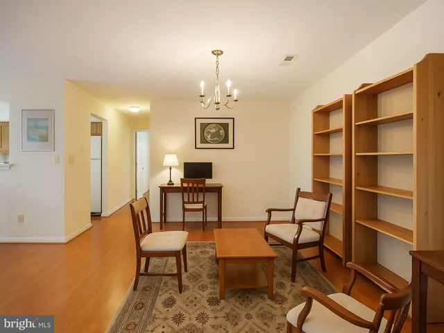 a living room with furniture a dining table and a piano table