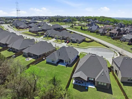an aerial view of a house with garden space and outdoor seating
