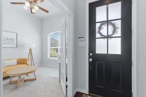 a view of a livingroom with furniture and a window