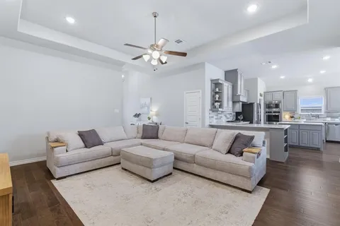 a living room with furniture and kitchen view