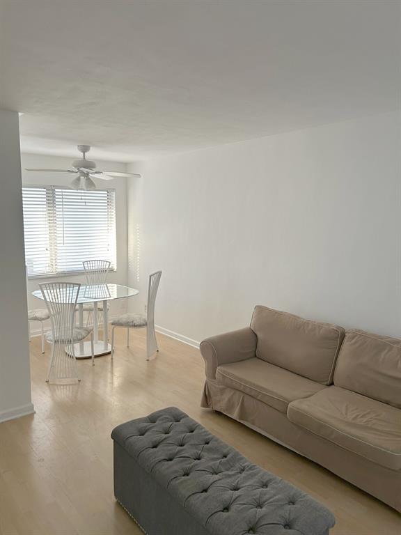 77 Hendricks Isle, Unit 9 Fort Lauderdale, FL 33301 - Photo 13 of 21 a living room with furniture and a dining table with wooden floor
