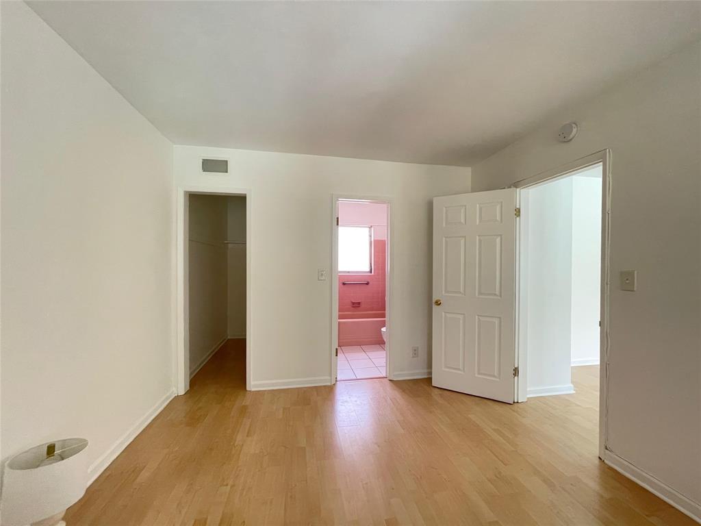 77 Hendricks Isle, Unit 9 Fort Lauderdale, FL 33301 - Photo 8 of 21 an empty room with wooden floor and windows