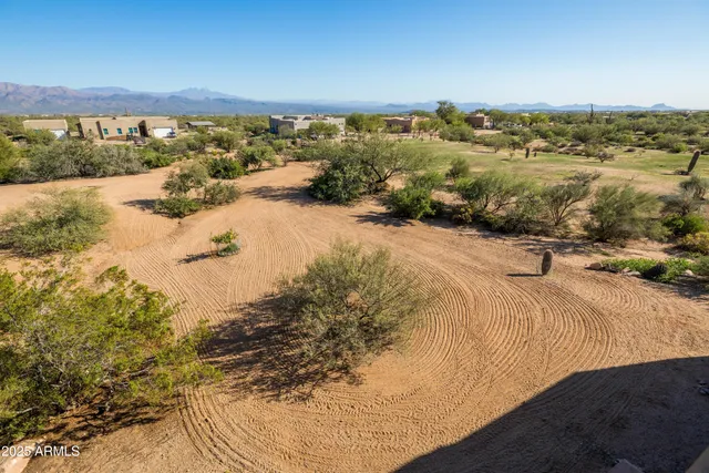 an aerial view of residential houses with city view