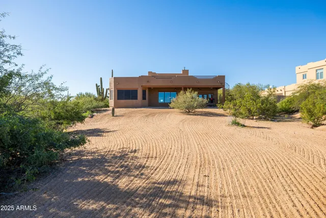 an aerial view of a house with a yard and lake view
