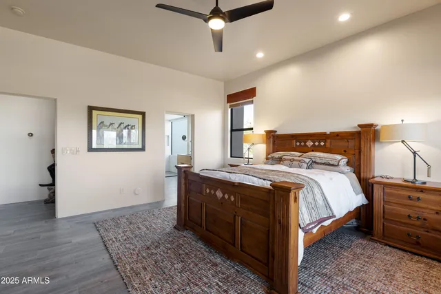 a bedroom with a large bed and a chandelier