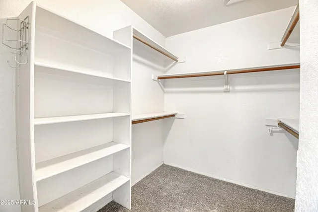 a bathroom with a granite countertop sink mirror vanity and toilet
