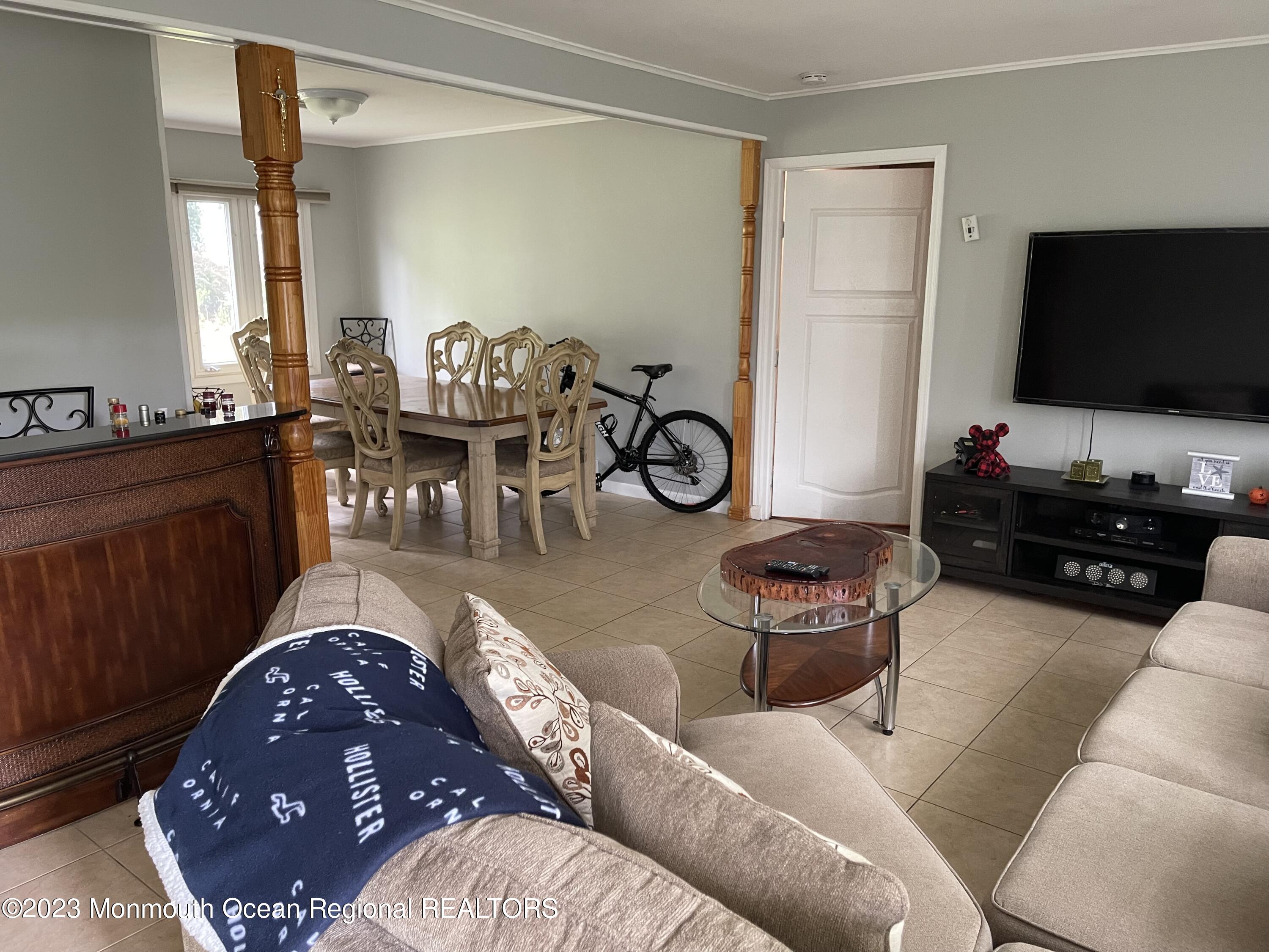233 Royal Place Elberon, NJ 07740 - Photo 4 of 10 a living room with furniture a flat screen tv and a window