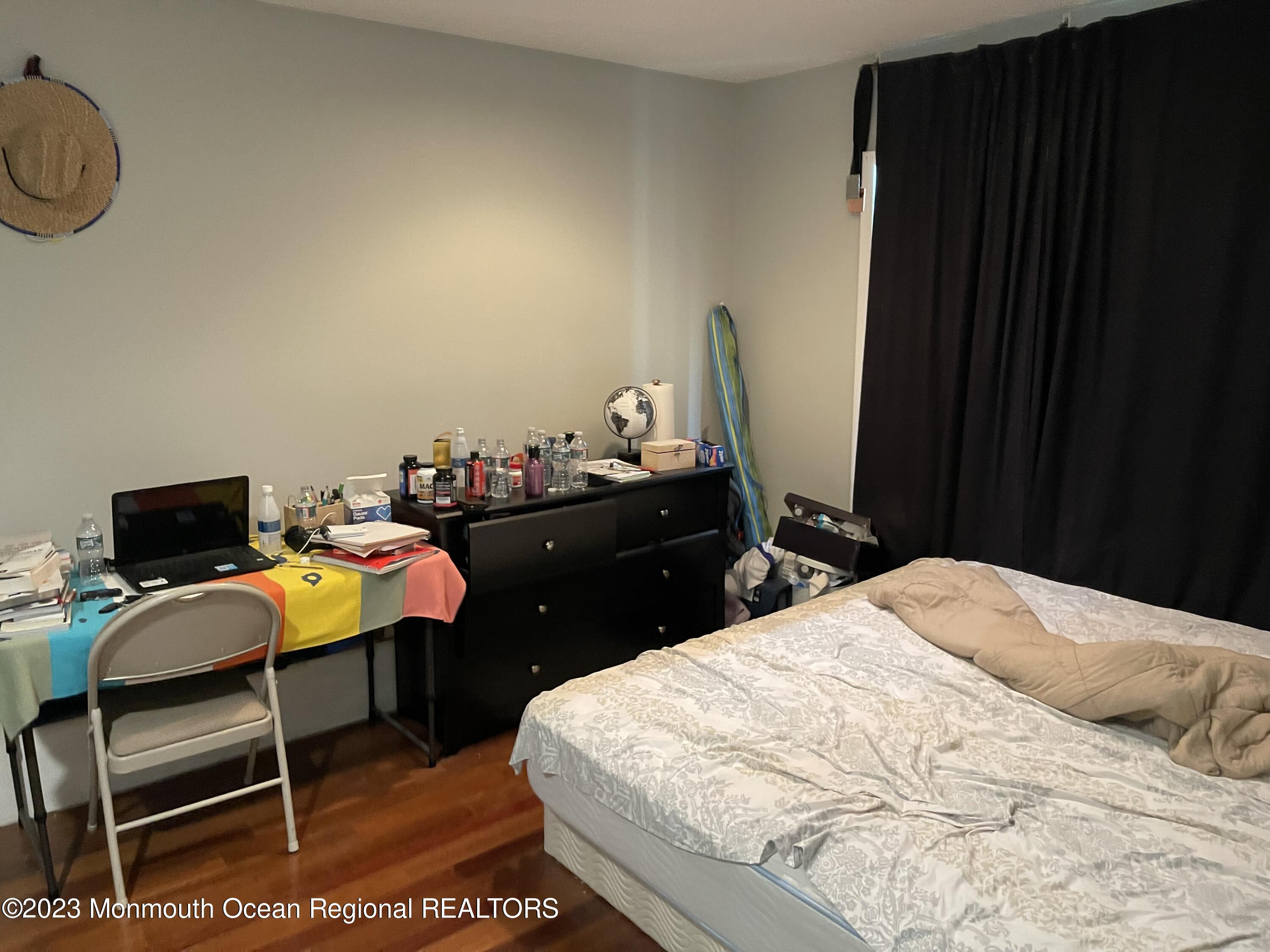 233 Royal Place Elberon, NJ 07740 - Photo 5 of 10 a bedroom with a bed and chair