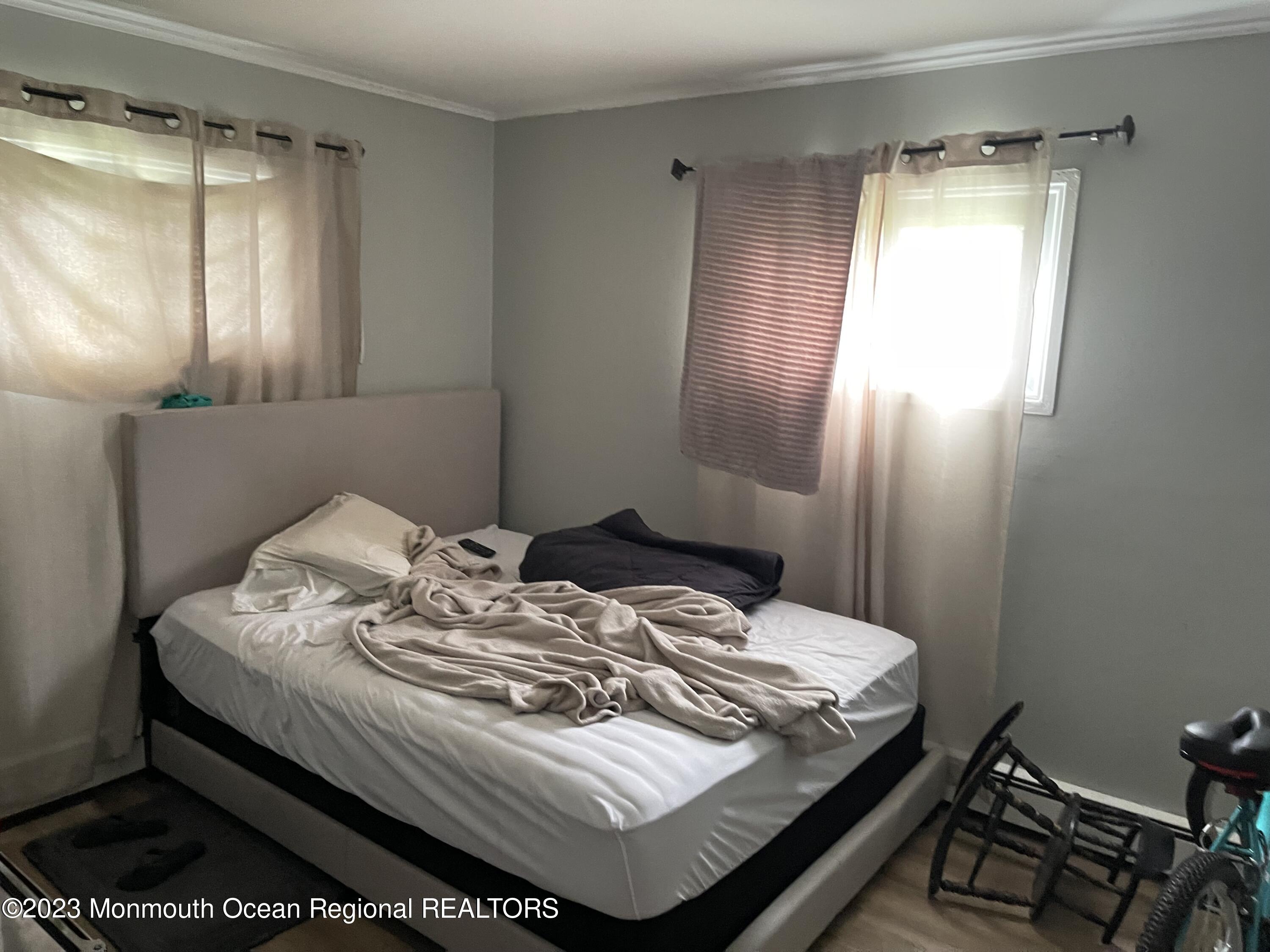 233 Royal Place Elberon, NJ 07740 - Photo 7 of 10 a bedroom with a bed and window
