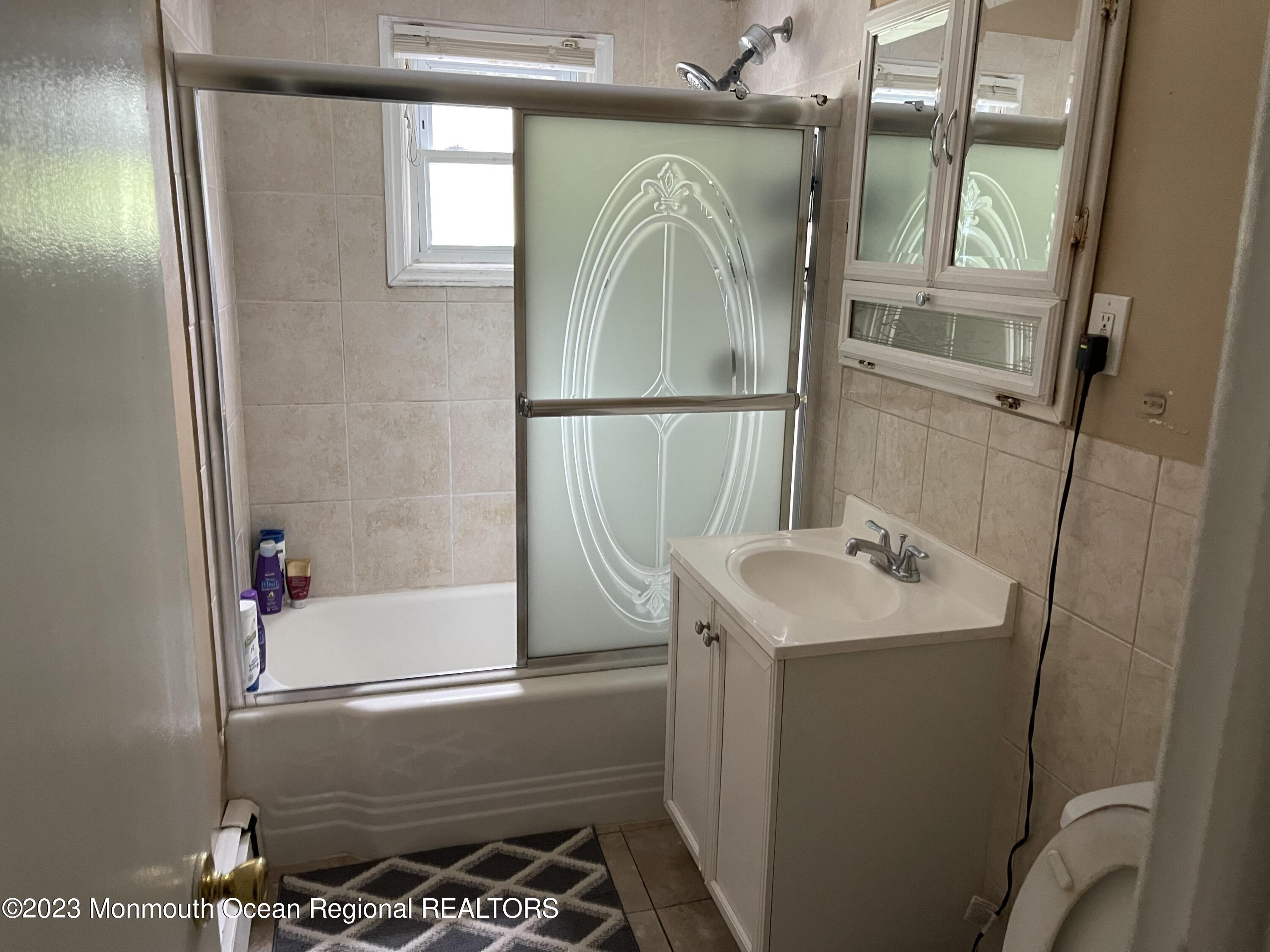 233 Royal Place Elberon, NJ 07740 - Photo 8 of 10 a bathroom with a sink and mirror with bathtub