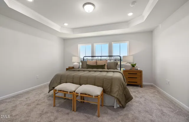 a spacious bedroom with a bed and window