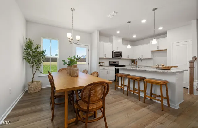 a kitchen with kitchen island granite countertop wooden cabinets a stove a sink and a center island