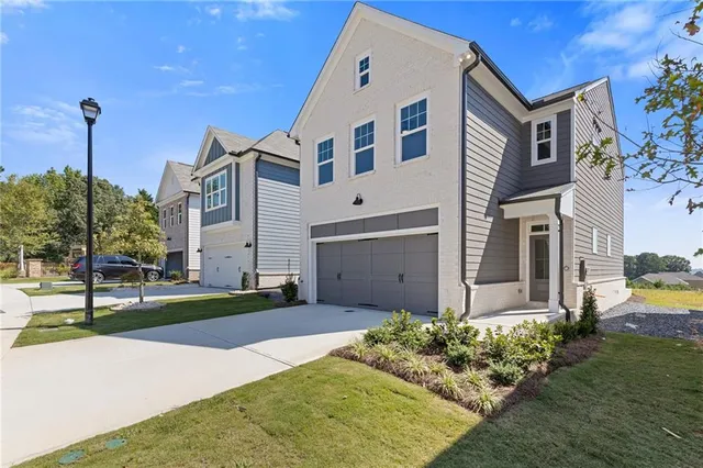 a front view of a house with a yard
