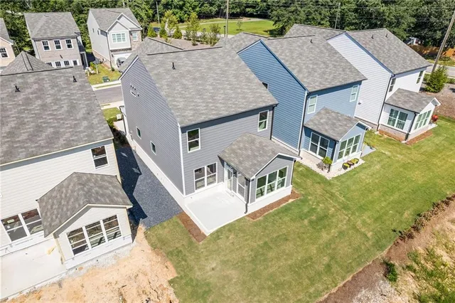 an aerial view of residential houses with outdoor space