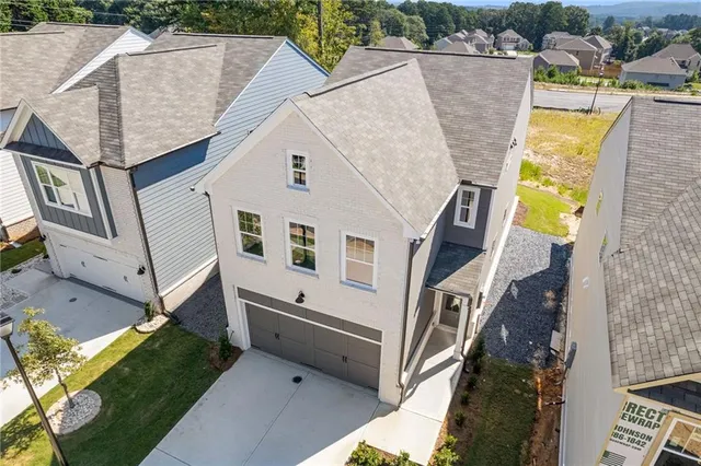 a aerial view of a house with a yard and stairs