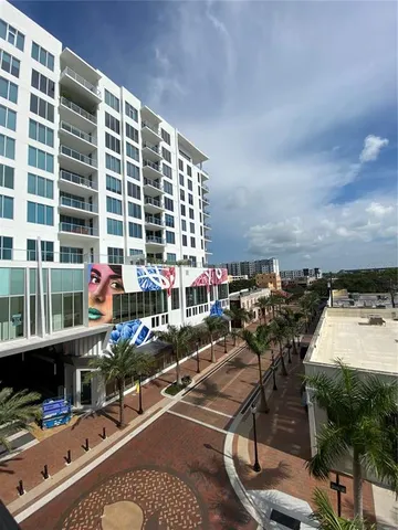 a car parked in front of white building