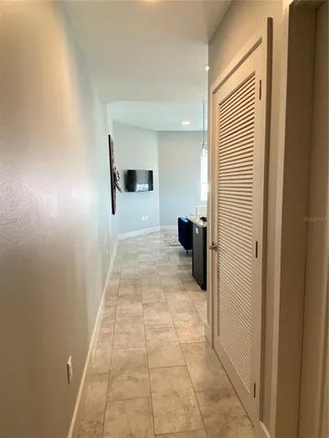 a living room with furniture a chandelier and a flat screen tv