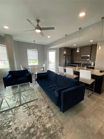 a kitchen with stainless steel appliances granite countertop a refrigerator stove top oven and sink