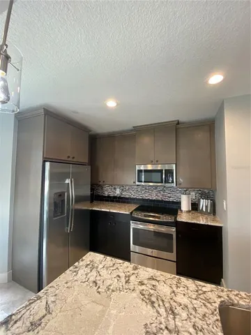 a spacious bedroom with a bed and a flat screen television