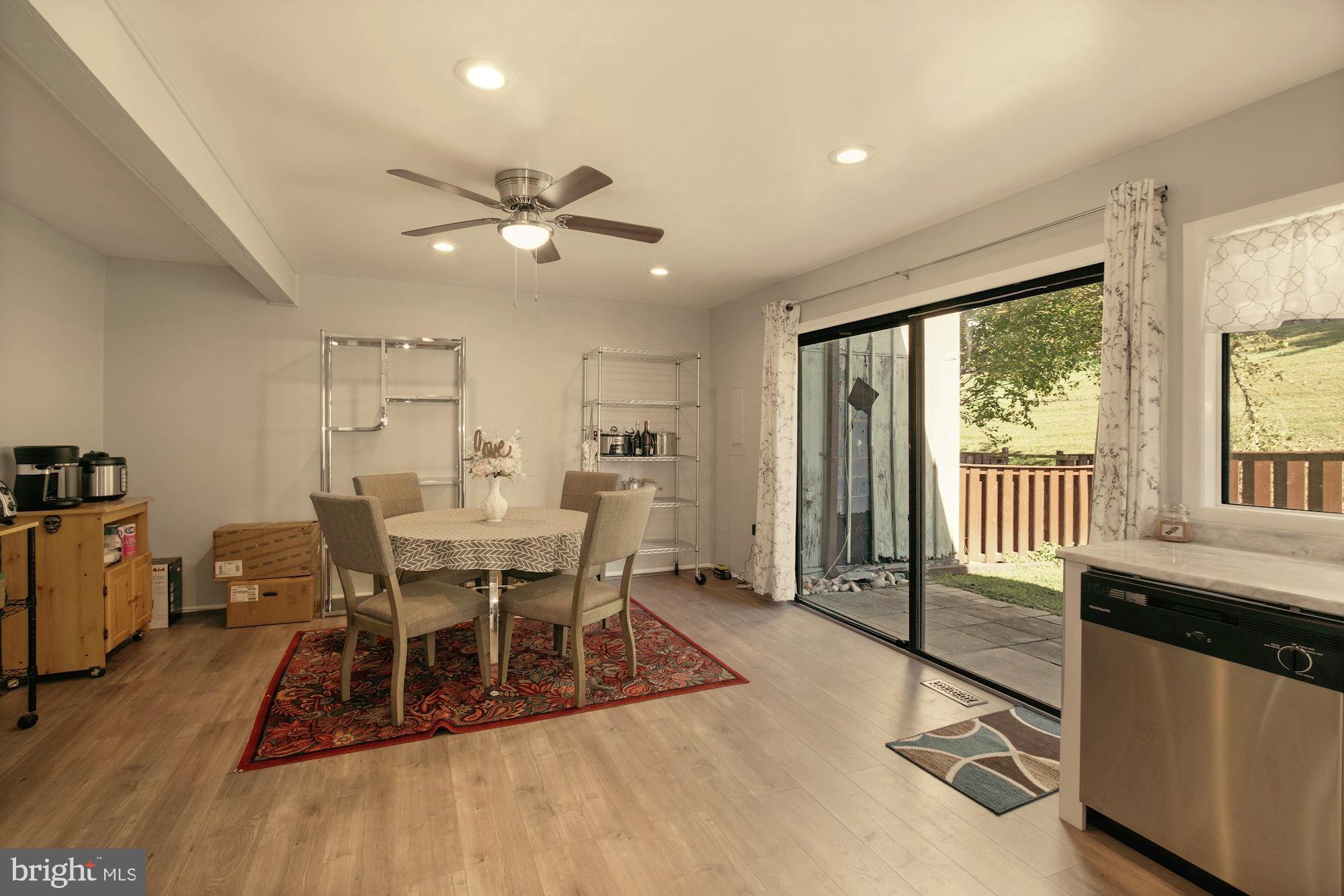 9122 Centerway Road Gaithersburg, MD 20879 - Photo 12 of 33 a dining room with wooden floor and a chandelier