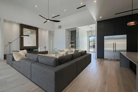 a living room with furniture and a chandelier