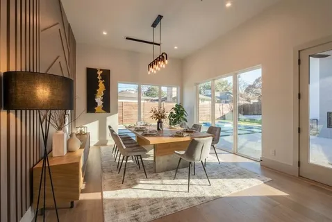 a view of a dining room with furniture wooden floor and a chandelier