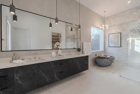 a bathroom with a double vanity sink mirror and
