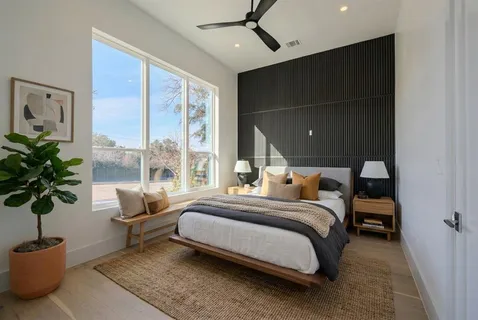 a bed room with a bed and a potted plant