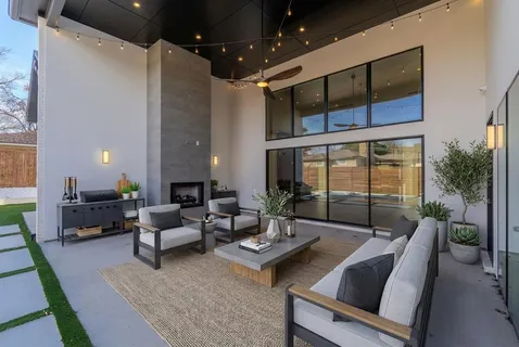 a living room with furniture and a floor to ceiling window