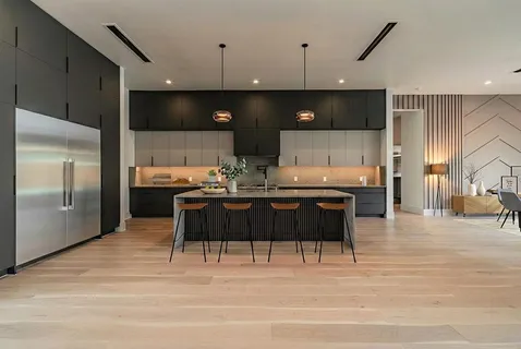 a kitchen with a table chairs refrigerator and microwave