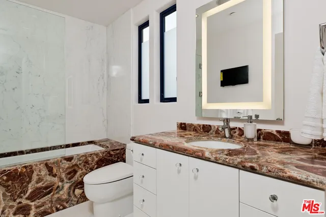 a kitchen with stainless steel appliances granite countertop a stove and a refrigerator