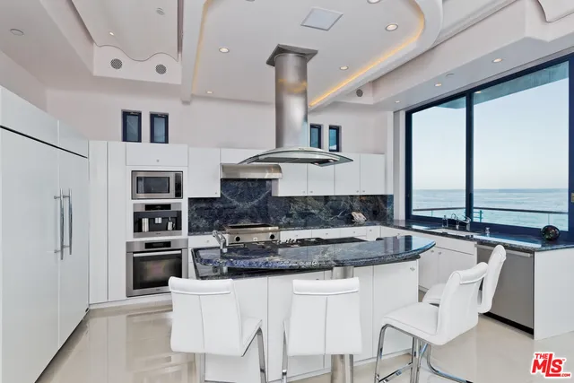 a large bathroom with a granite countertop double vanity sink a mirror and a shower