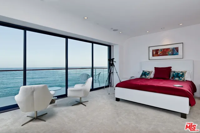 a living room with furniture and a dining table